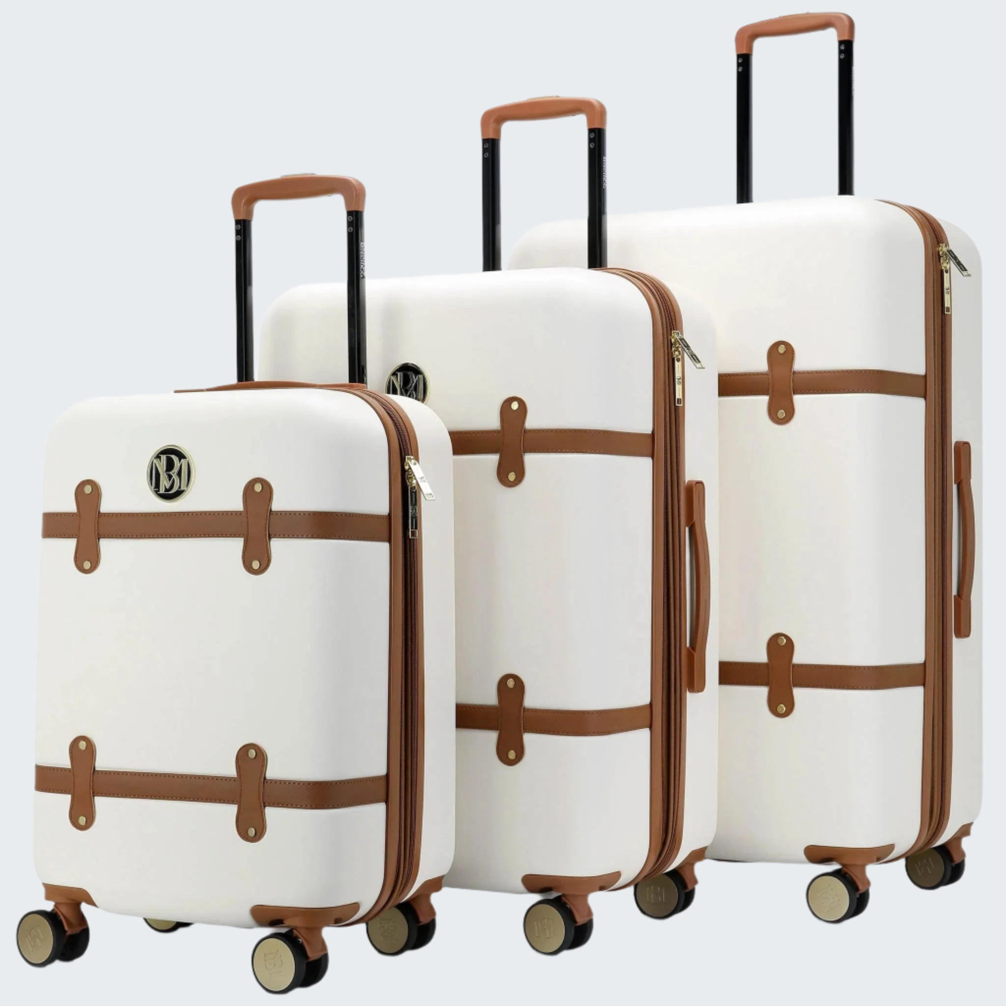 Set of three white suitcases with brown accents on a white background