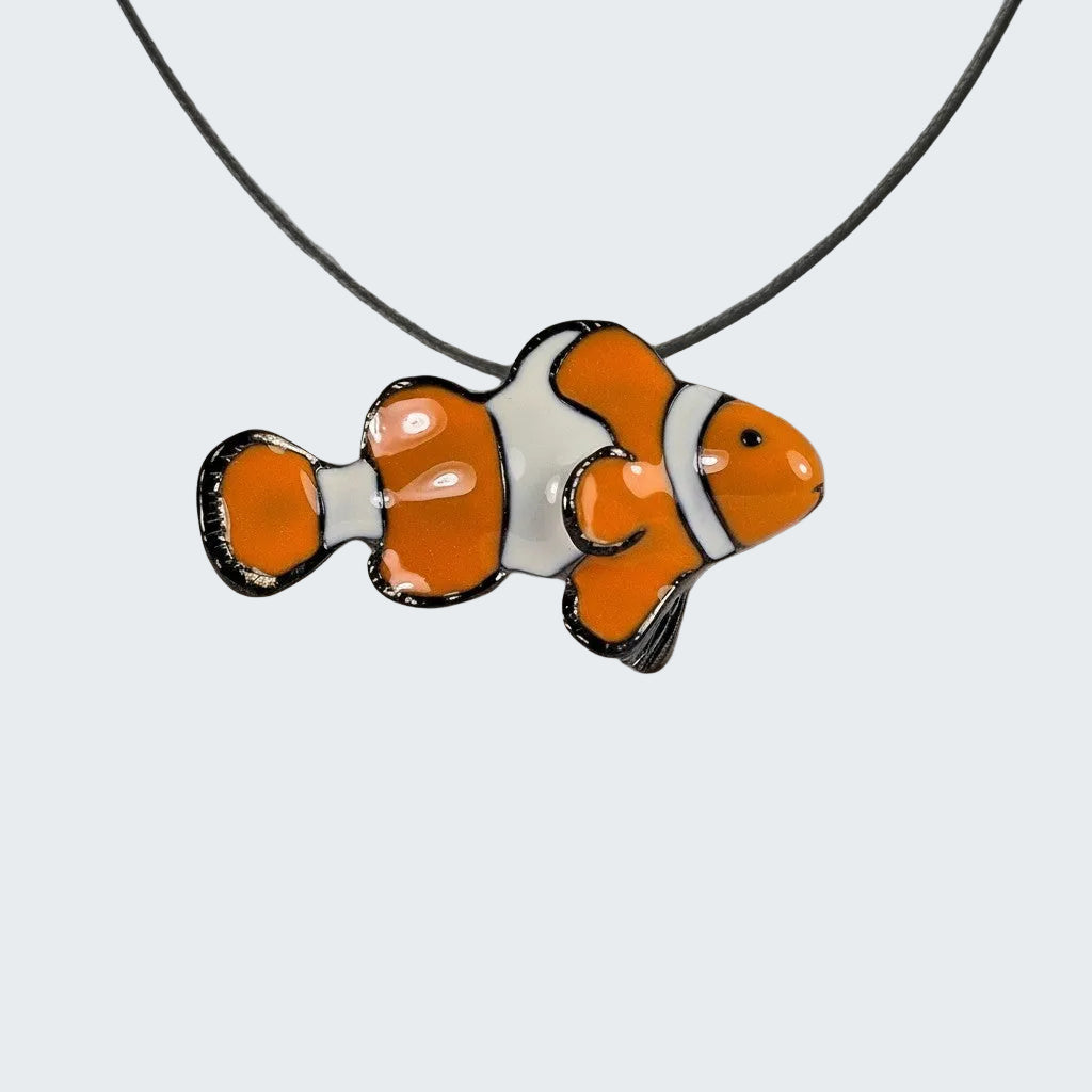 Clownfish pendant on a string against a wooden background