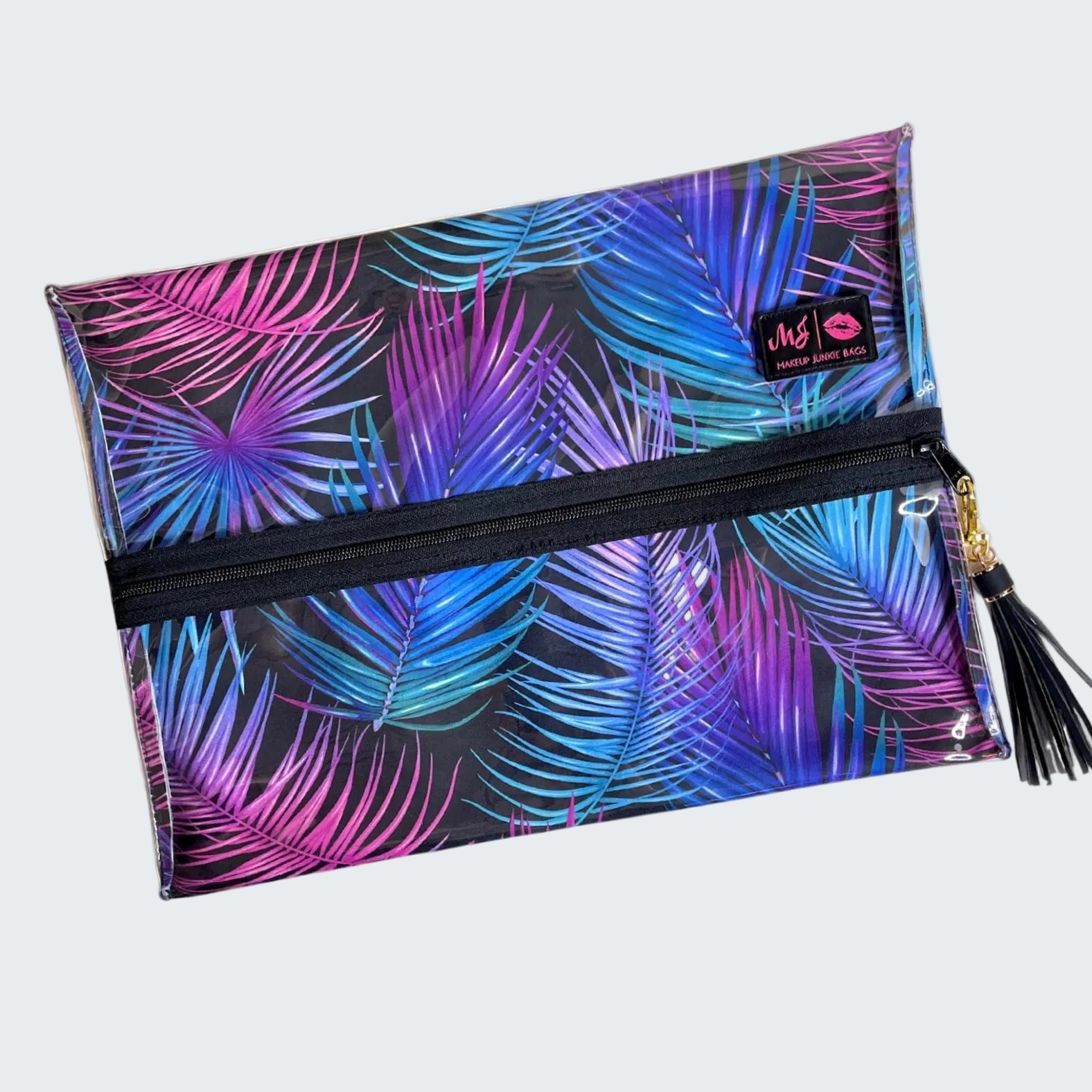 Pouch with colorful palm leaf pattern and tassel on a white background