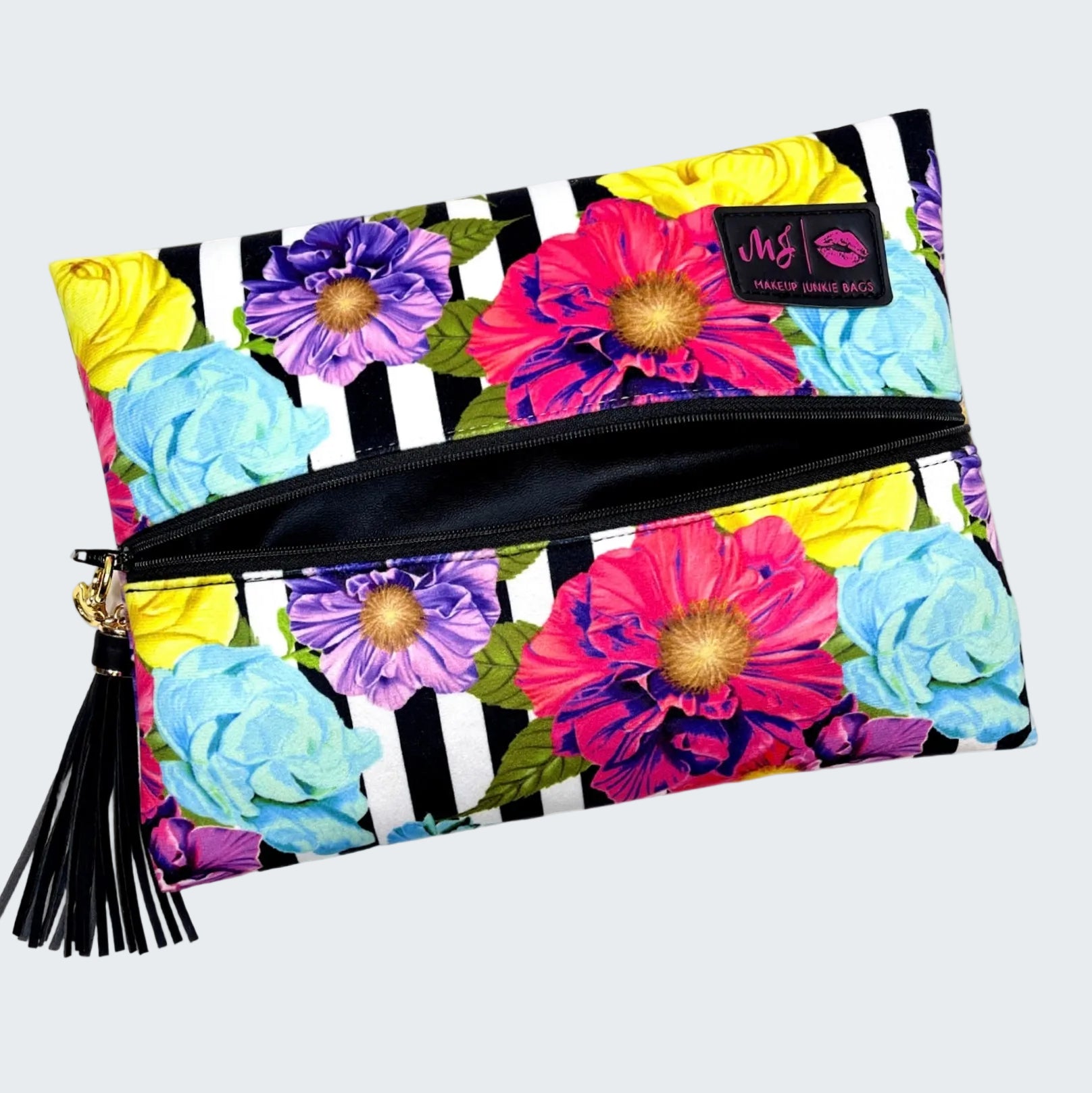 Makeup bag with colorful floral design and black and white striped pattern on a white background