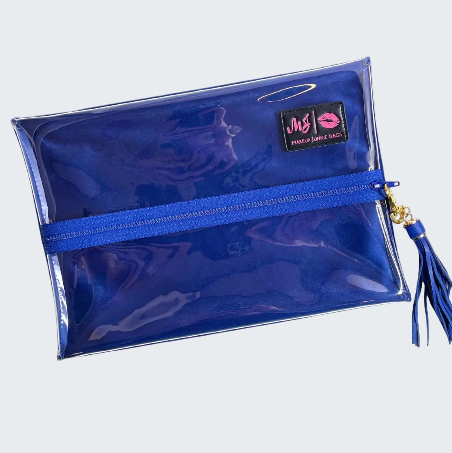 Blue makeup bag with a tassel on a white background
