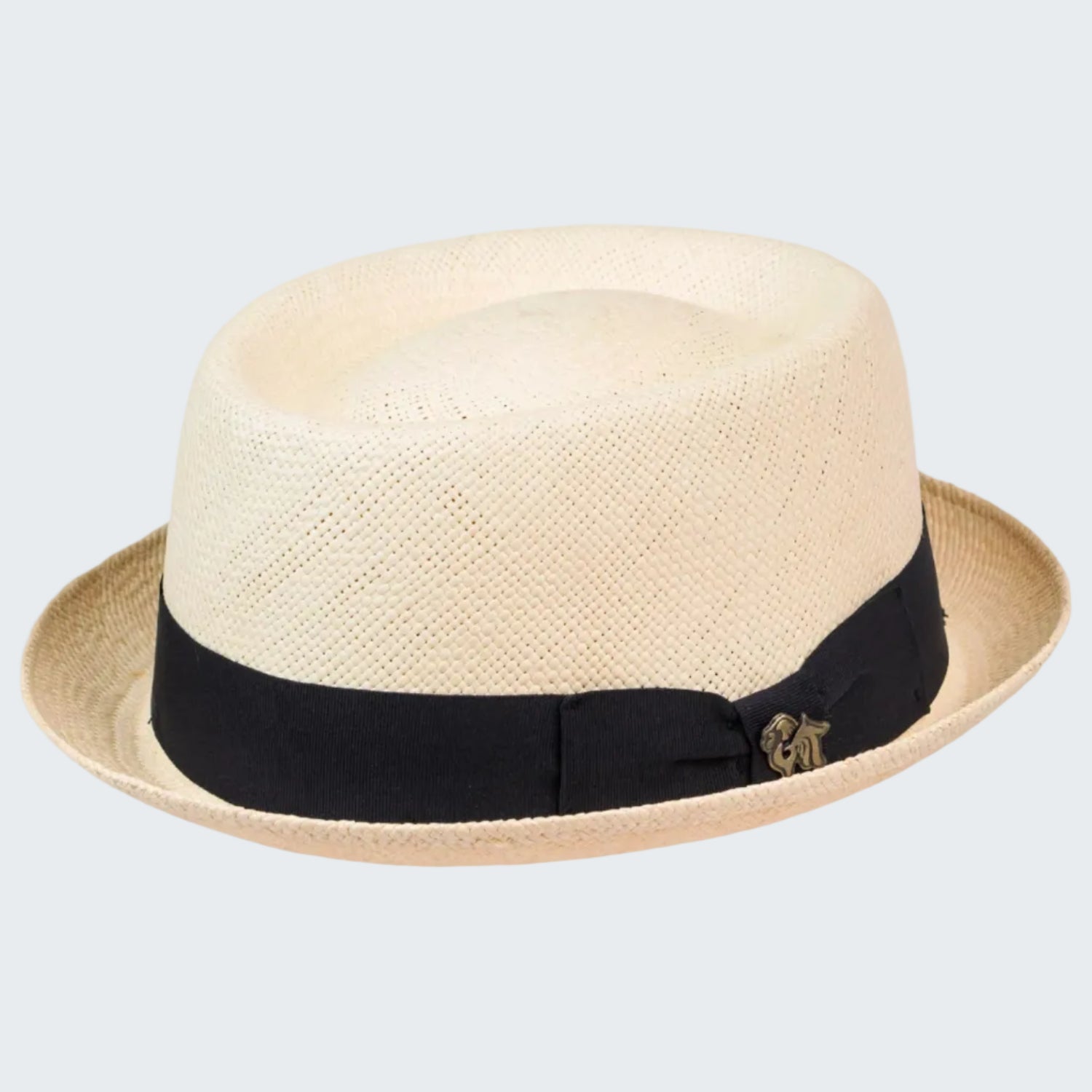 Beige straw hat with a black band and gold emblem on a white background