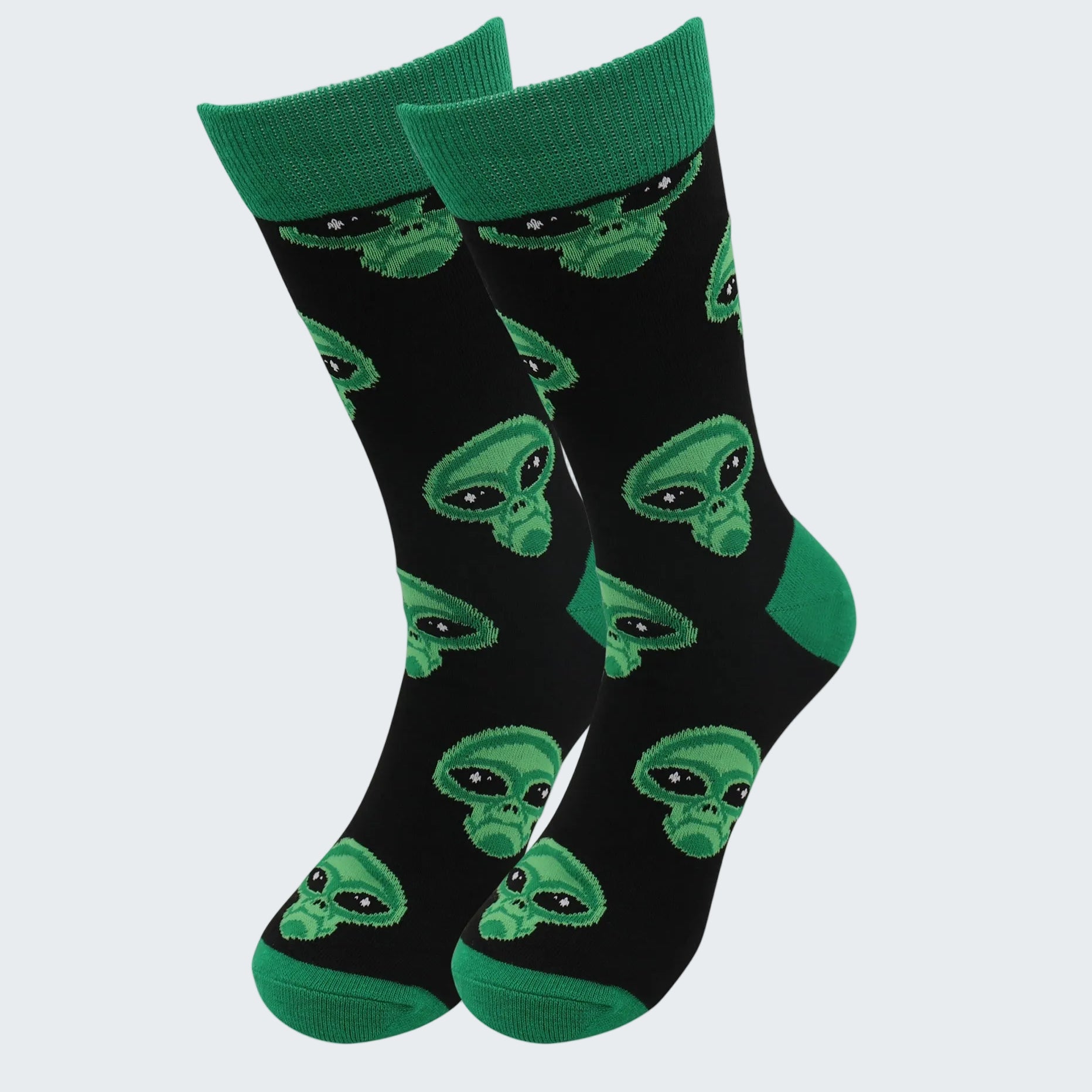 Black socks with green alien patterns on a white background