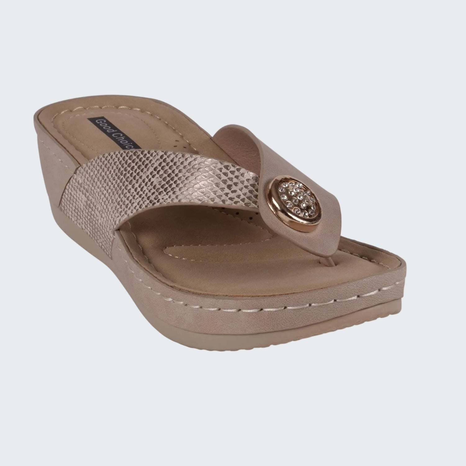 Beige wedge sandal with a decorative strap on a white background