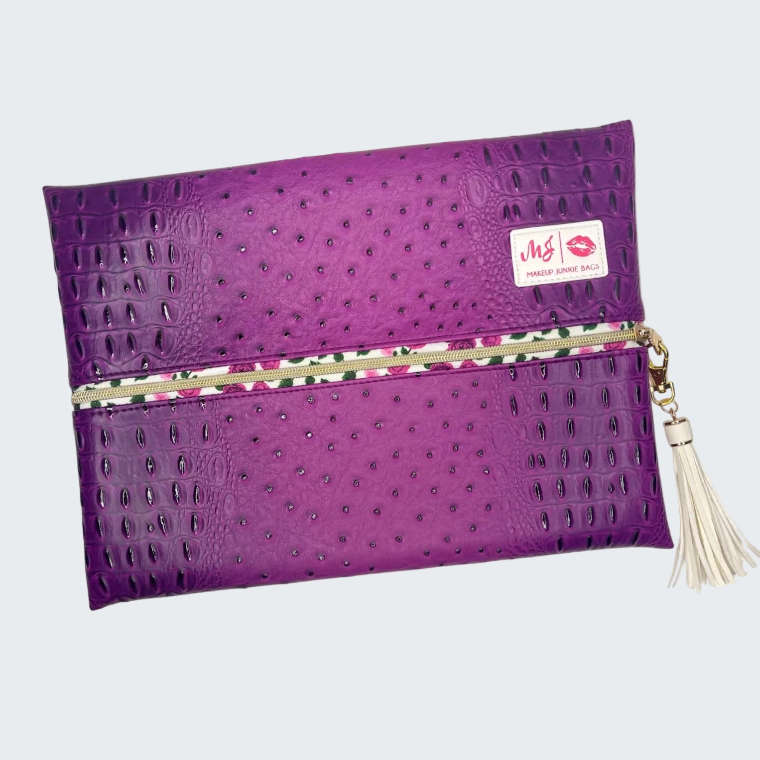 Purple clutch bag with a visible brand logo on a white background