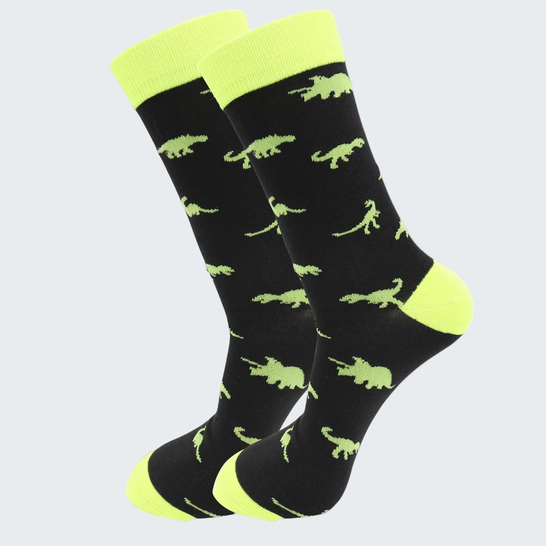 Black socks with green dinosaur pattern and neon yellow accents on a white background