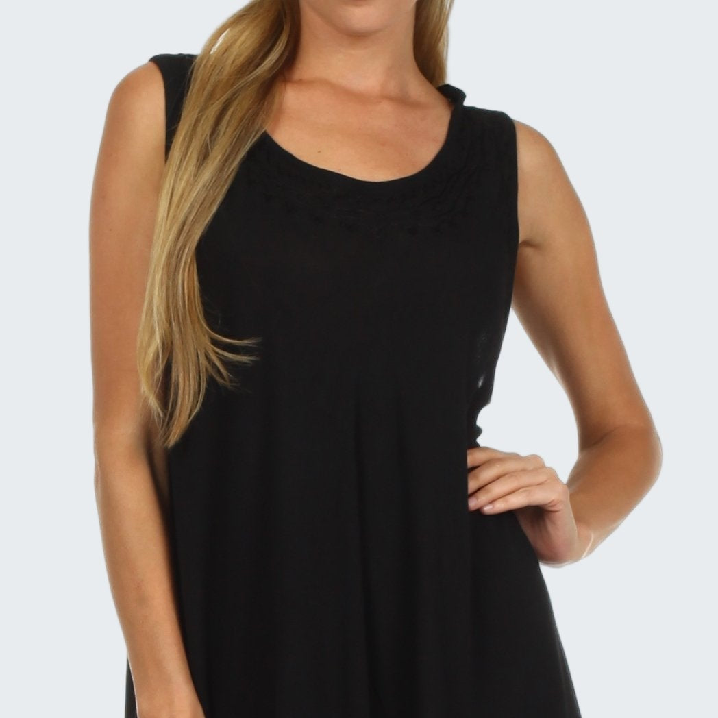 Black sleeveless dress worn by a model on a white background