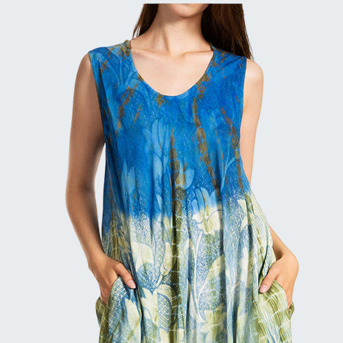 Blue and green patterned dress worn by a model on a white background