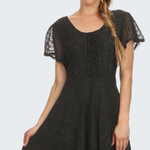 Black lace dress worn by a model on a white background