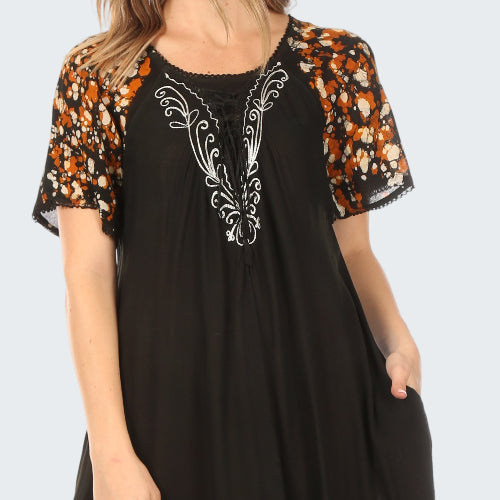 Black dress with orange and white patterns on a white background