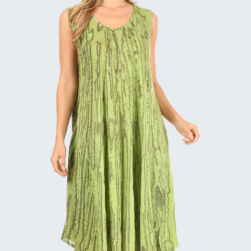 Green patterned dress worn by a model on a white background