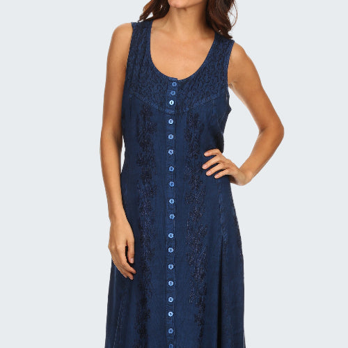 Woman wearing a navy blue sleeveless dress with buttons on a white background