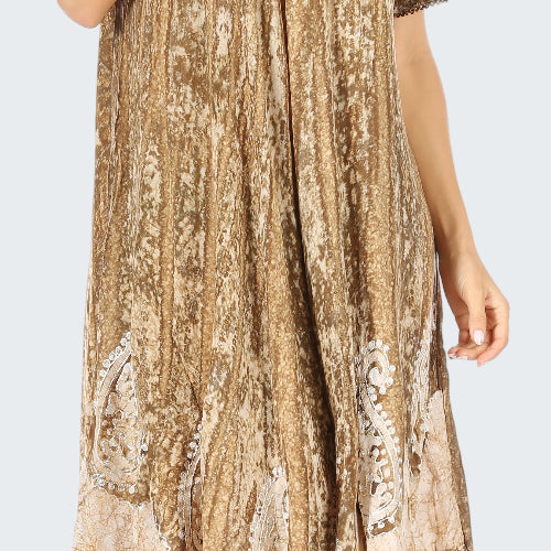 Woman wearing a patterned dress with lace details on a white background