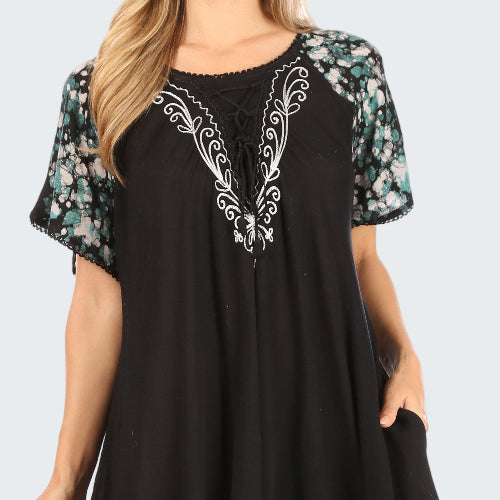 Black dress with floral patterns on a white background