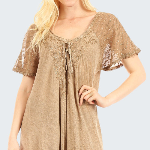 Beige lace dress worn by a model on a white background