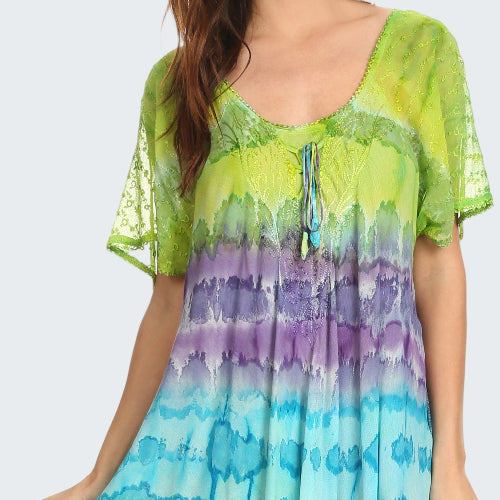 Woman wearing a tie-dye dress with green, purple, and blue gradient.