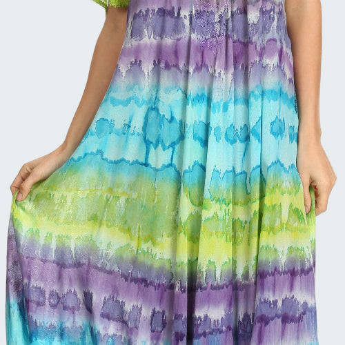 Woman wearing a tie-dye dress with green, purple, and blue gradient.