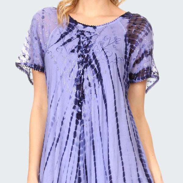 Woman wearing a long, light purple tie-dye dress with a subtle pattern.