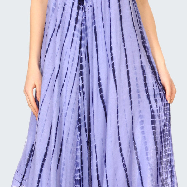 Woman wearing a long, light purple tie-dye dress with a subtle pattern.