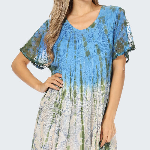 Woman wearing a blue and green patterned dress on a white background
