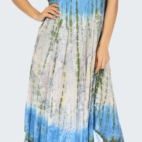 Woman wearing a blue and green patterned dress on a white background