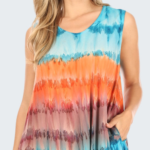 Woman wearing a tie-dye dress with orange, blue, and pink colors.