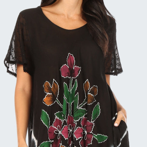 Black dress with floral embroidery on a white background