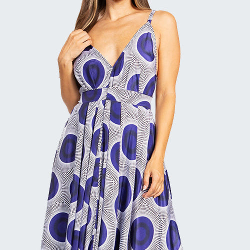 Woman wearing a sleeveless dress with a blue and white pattern on a white background