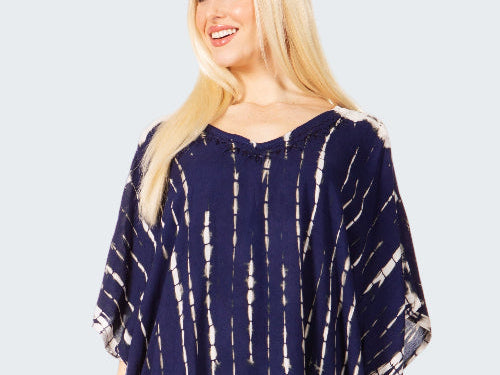 Woman wearing a navy blue tie-dye dress on a white background