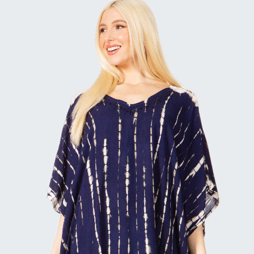 Woman wearing a navy blue tie-dye dress on a white background