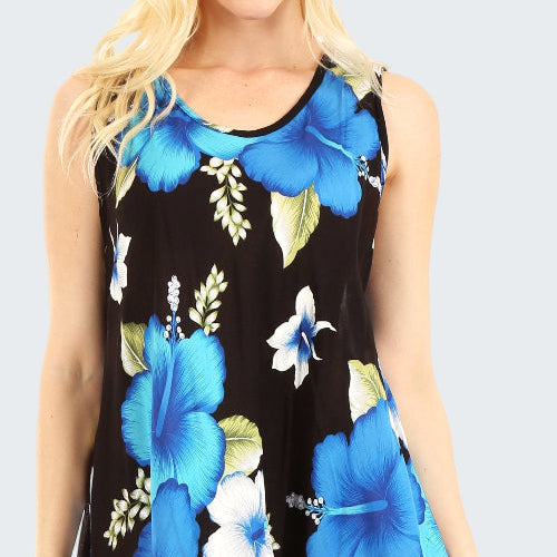 Woman wearing a sleeveless dress with blue floral pattern on a black background