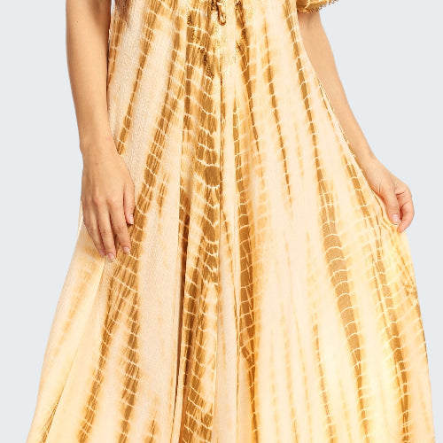 Woman wearing a yellow tie-dye dress on a white background