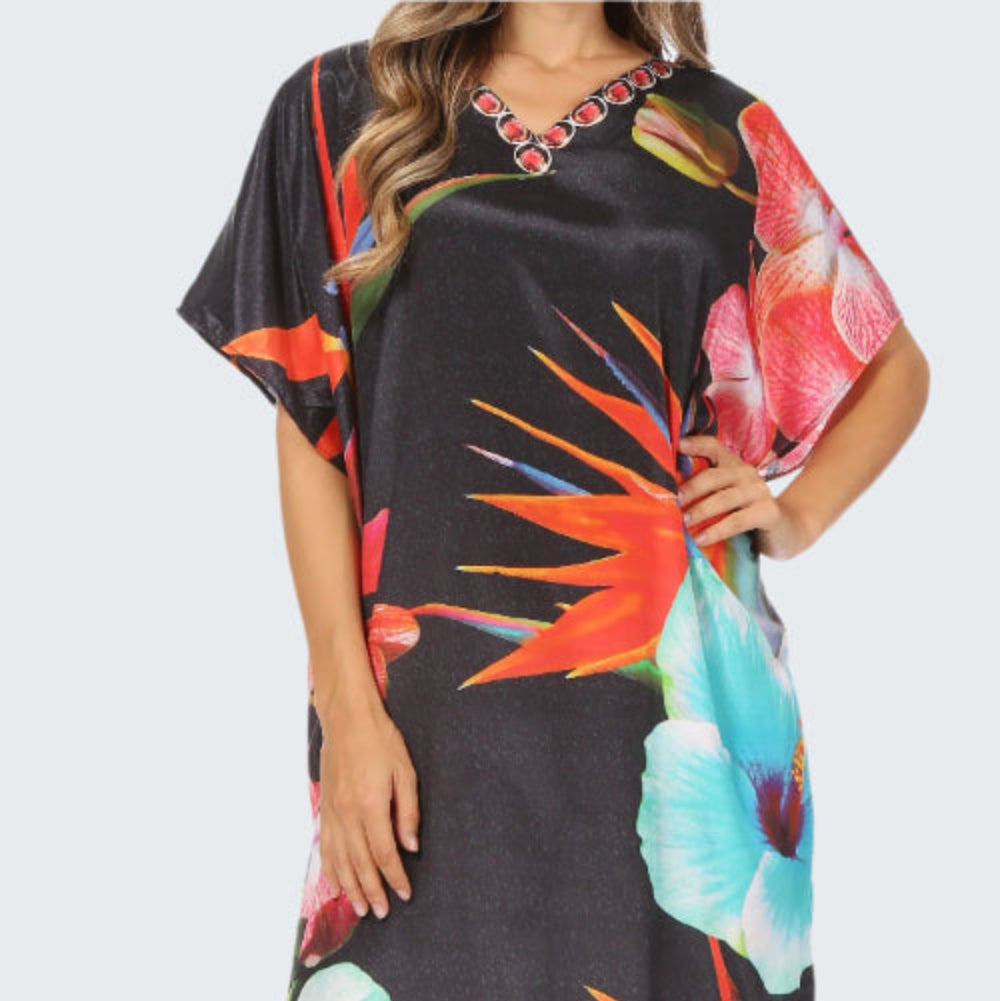 Black dress with colorful floral pattern worn by a model on a white background