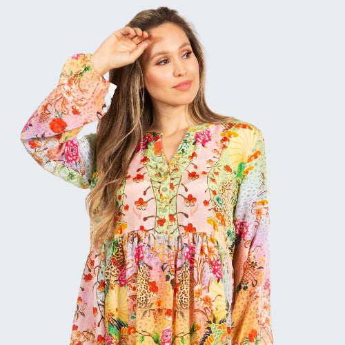 Woman wearing a colorful floral dress on a white background