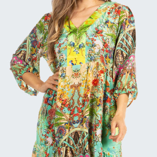 Woman wearing a colorful floral dress on a white background