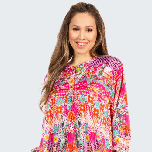 Woman wearing a colorful patterned dress on a white background