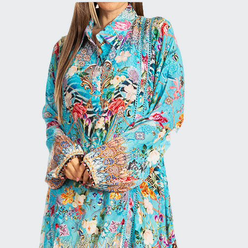 Woman wearing a colorful floral dress on a white background