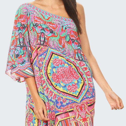 Woman wearing a colorful patterned dress on a white background