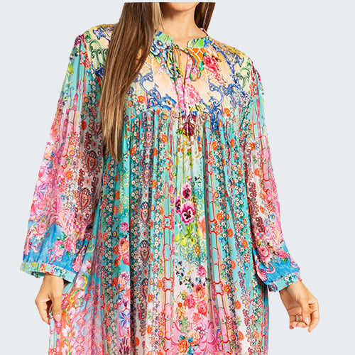 Woman wearing a colorful floral dress on a white background