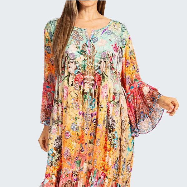 Woman wearing a colorful floral dress on a white background