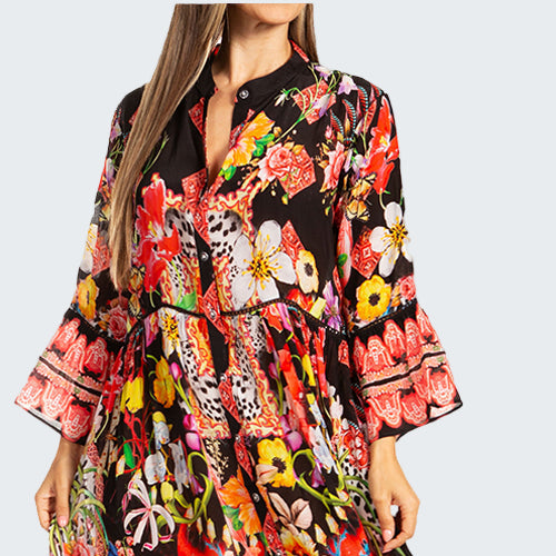 Woman wearing a colorful floral dress on a white background