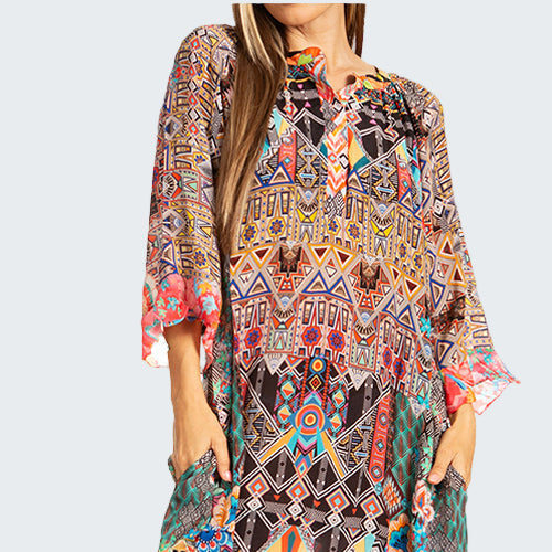 Colorful patterned dress worn by a model on a white background