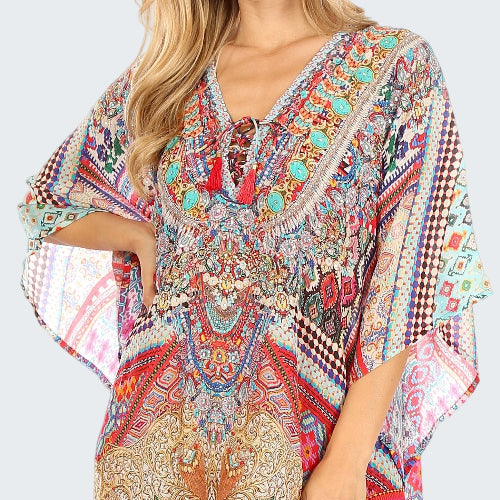 Colorful patterned dress worn by a model on a white background