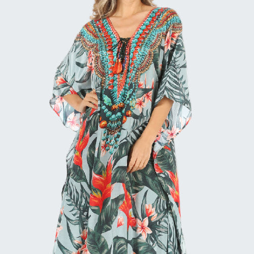 Long floral dress with a tropical pattern on a white background