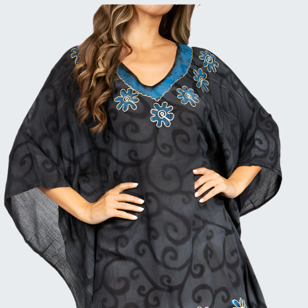 Black and blue patterned dress with floral designs on a white background