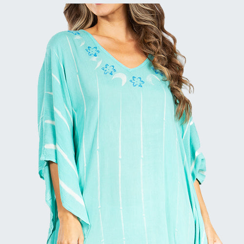 Woman wearing a light blue dress with floral patterns on a white background