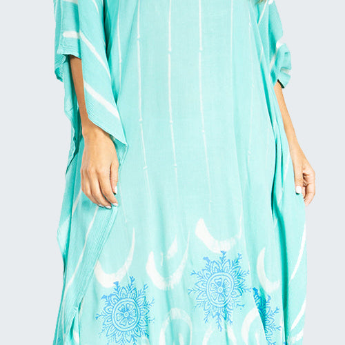 Woman wearing a light blue dress with floral patterns on a white background