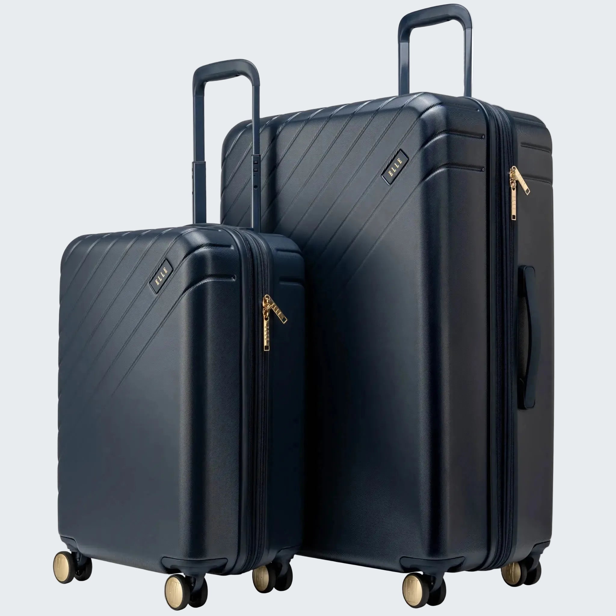 Two navy blue suitcases with gold zippers on a white background