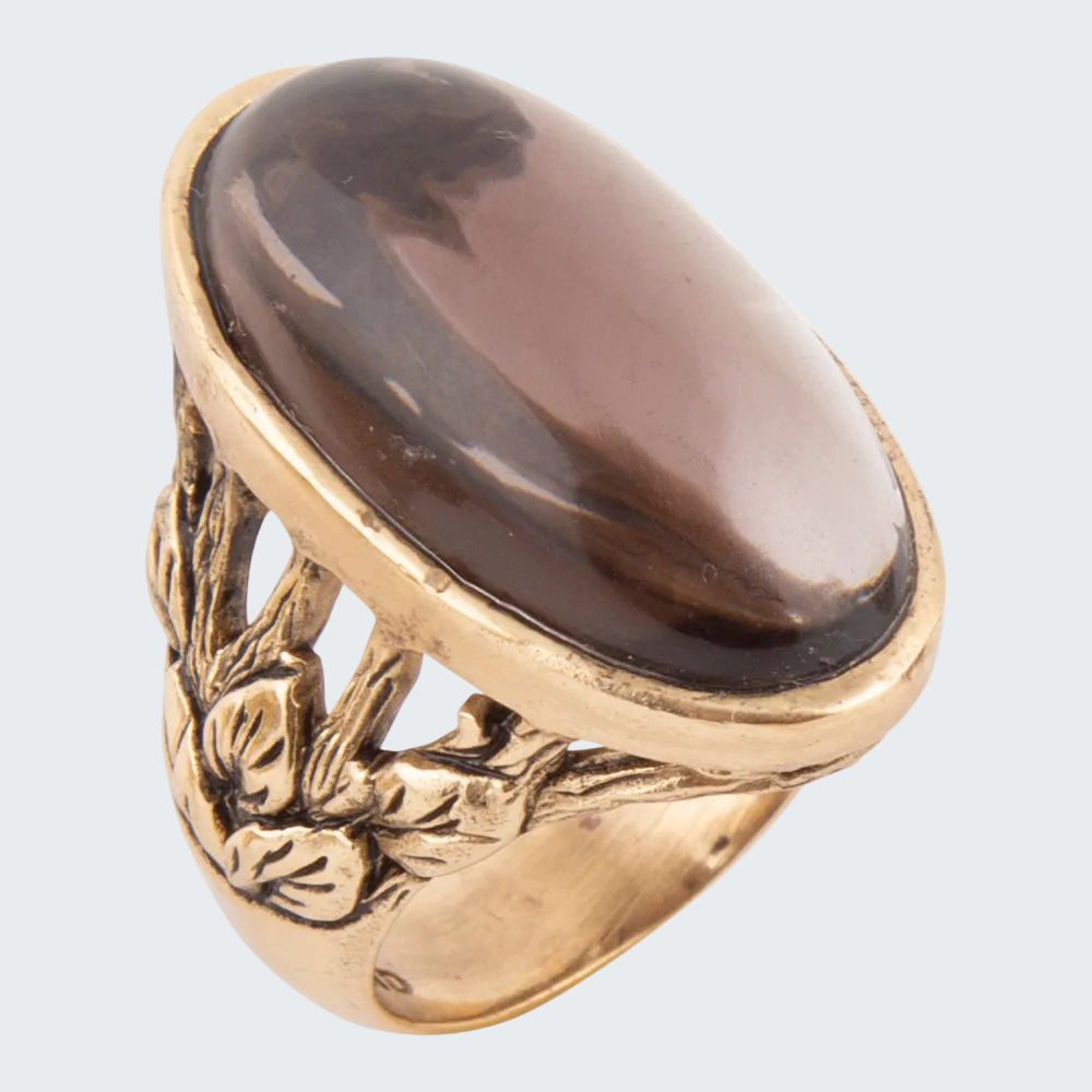 Gold ring with a large brown stone on a white background