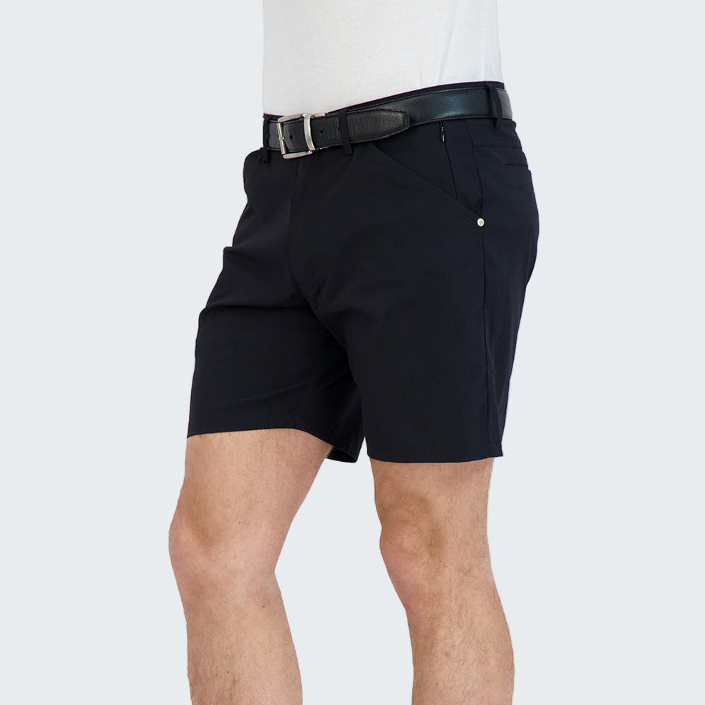 Person wearing black shorts and black high-top sneakers on a white background